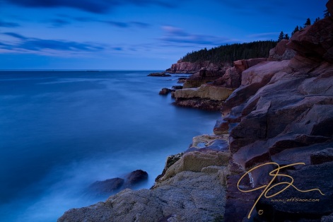 Otter Cliffs in Acadia National Park, photographed during the blue hour, that time before twilight when everything has a blue color to it. This long, 61 second exposure show the movement of the clouds and the surf along the rugged granite shore leading up to Otter Cliffs in the distance.